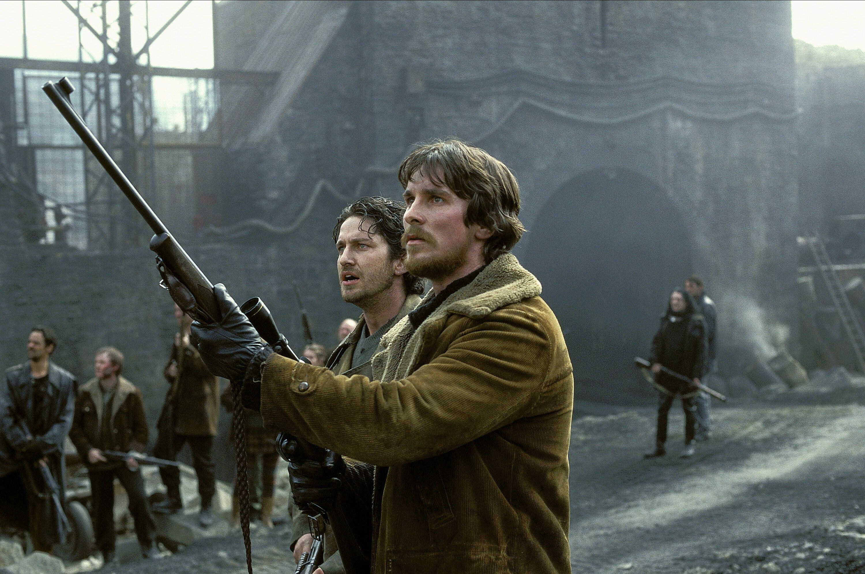 Two men in a castle hold their guns and stare at a threat in the sky