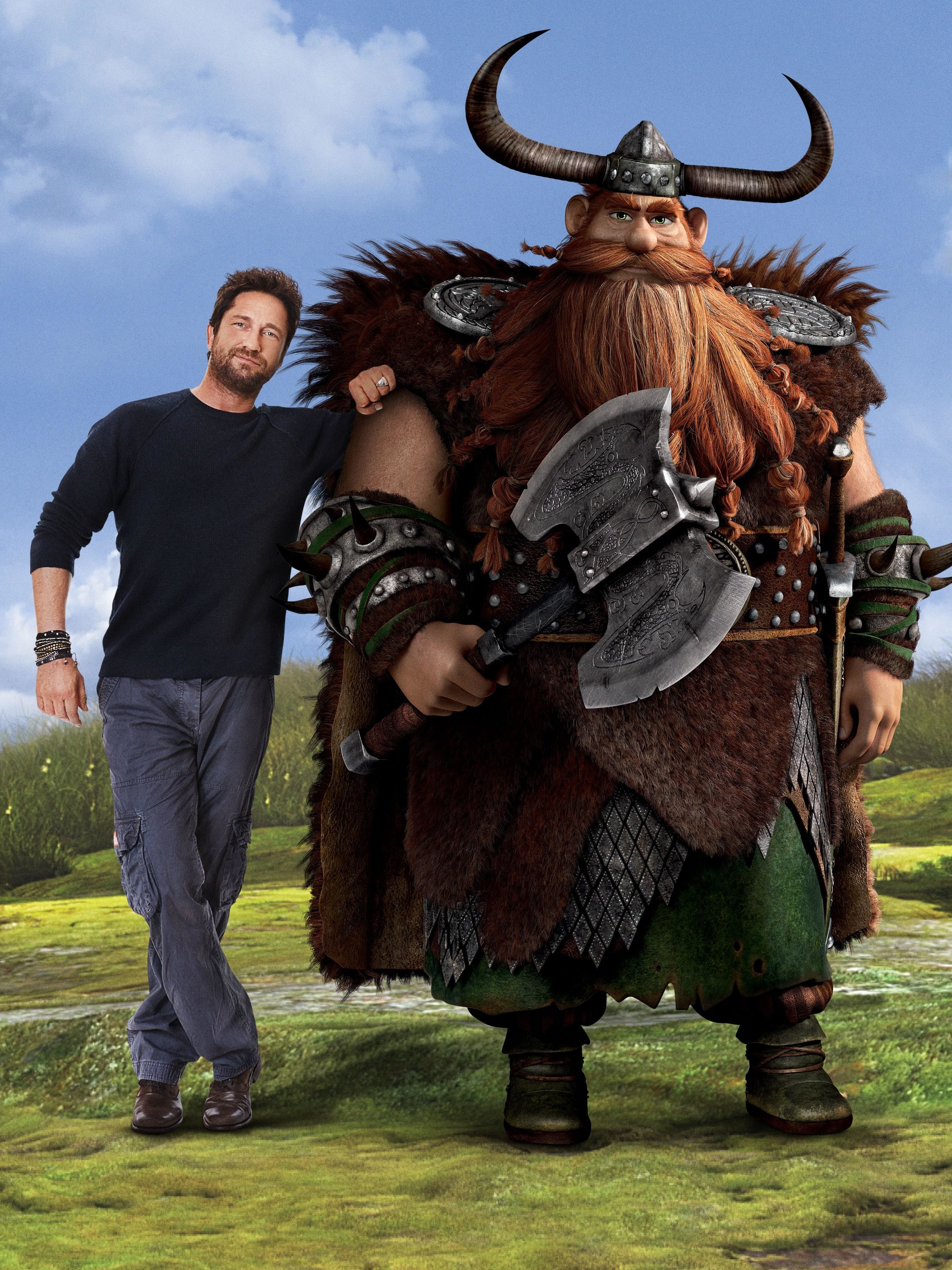 Gerard Butler takes a promotional photo next to his CGI counterpart, Stoick