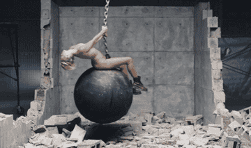 miley stting on top of a wrecking ball