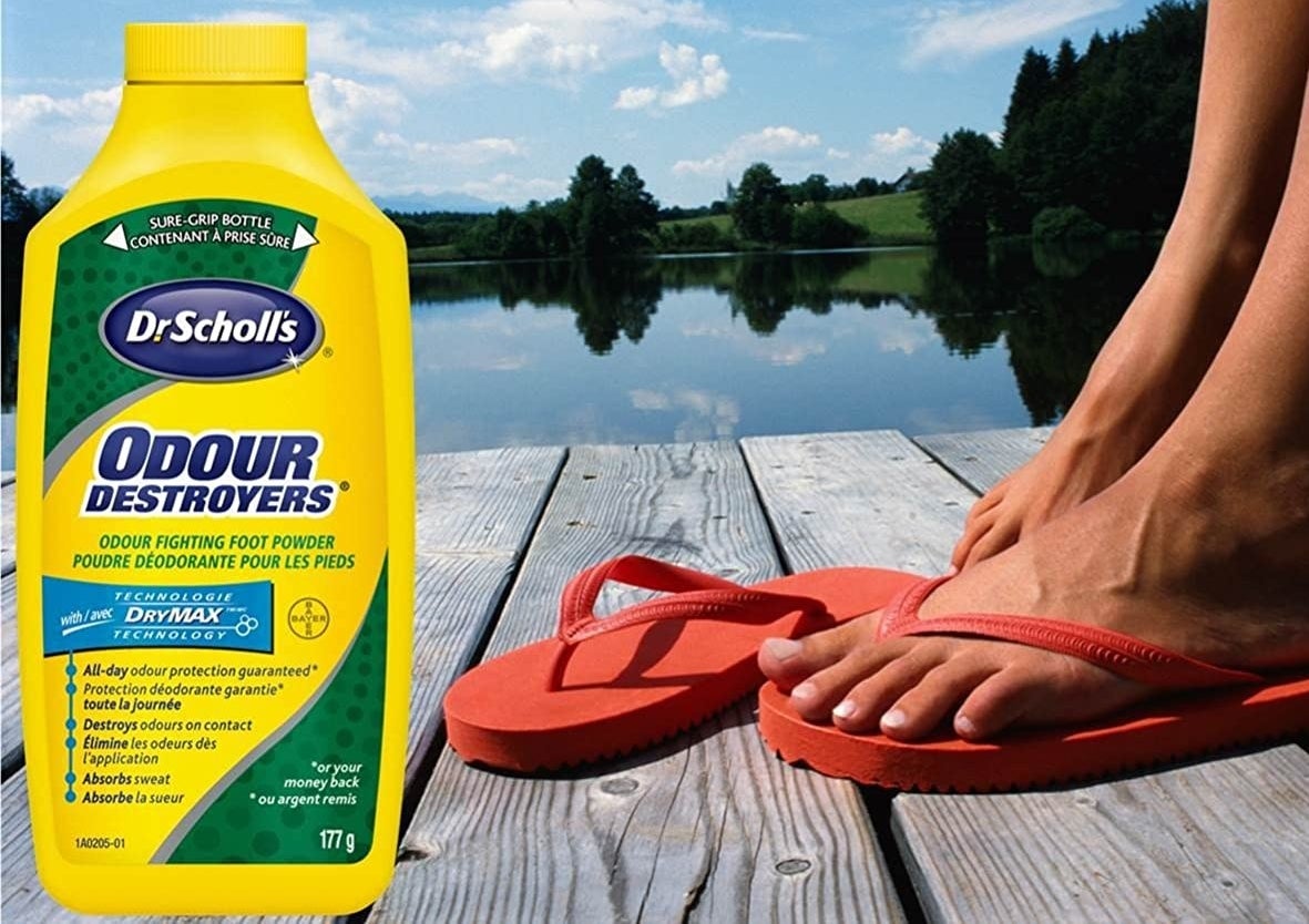 A bottle of Odour Destroyers beside a person putting on flip flops on a dock