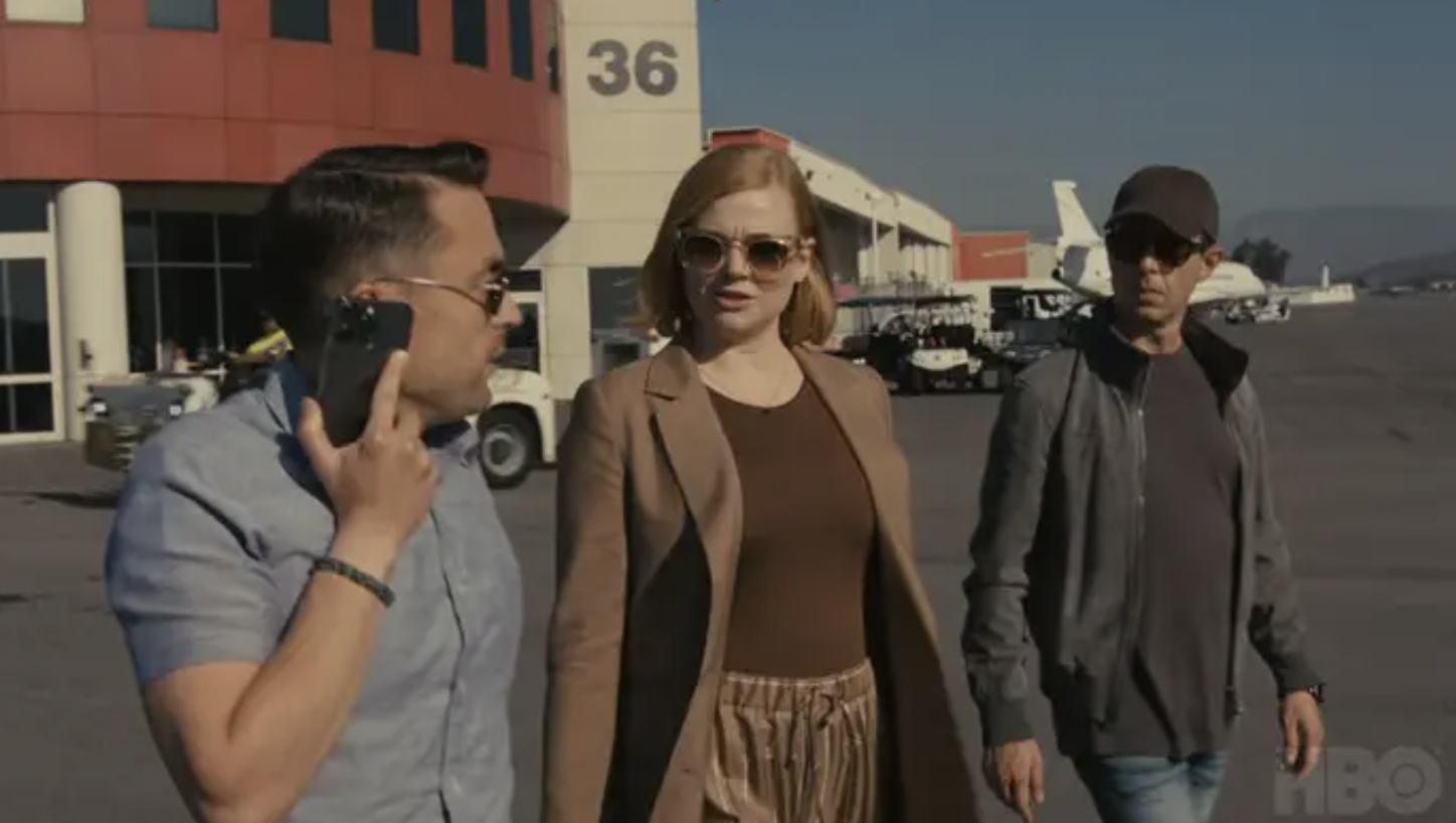 three roy siblings talking and walking outside an airport