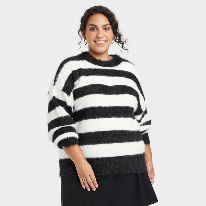 A model wearing the striped sweater with blue and white