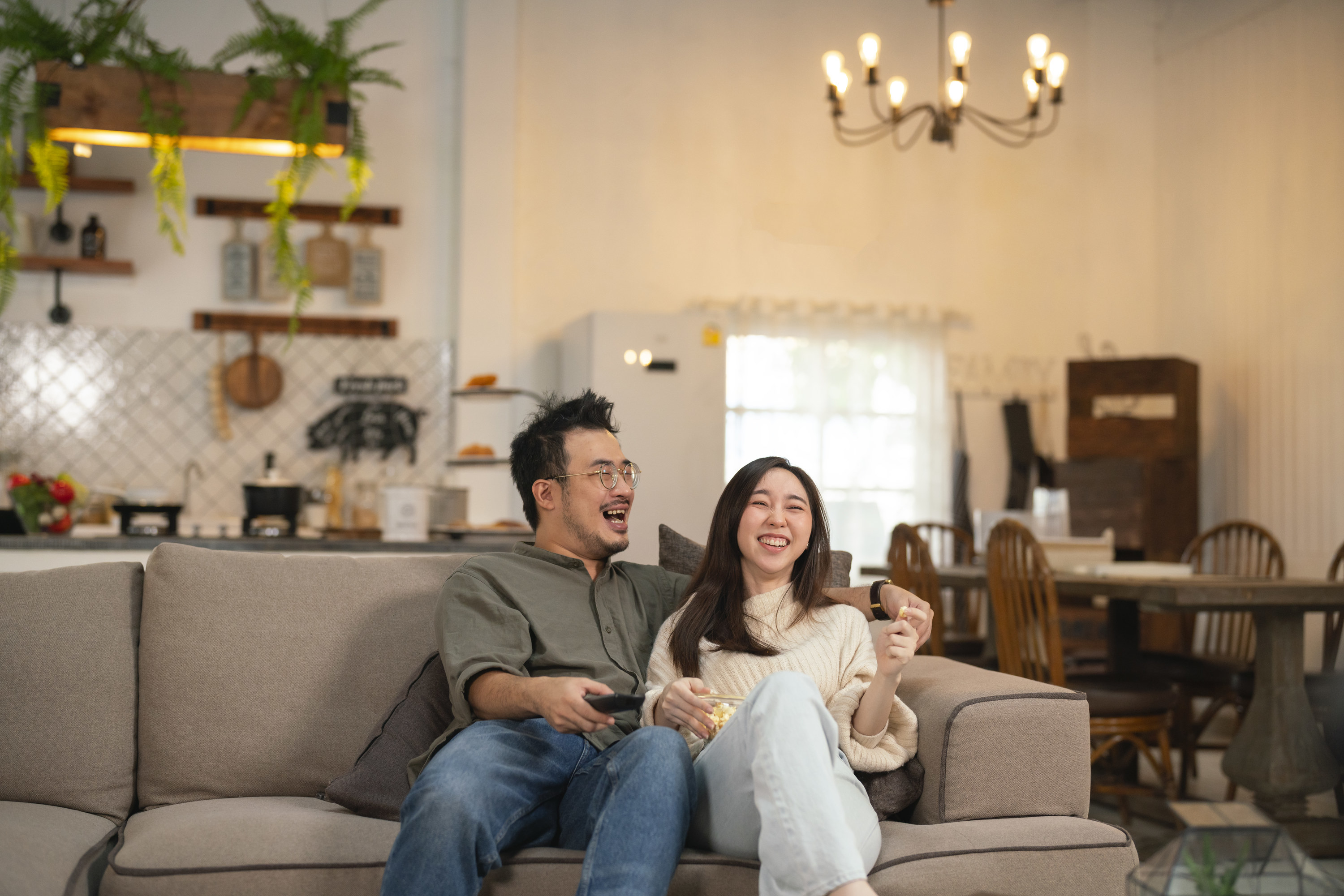 couple laughing while watching tv