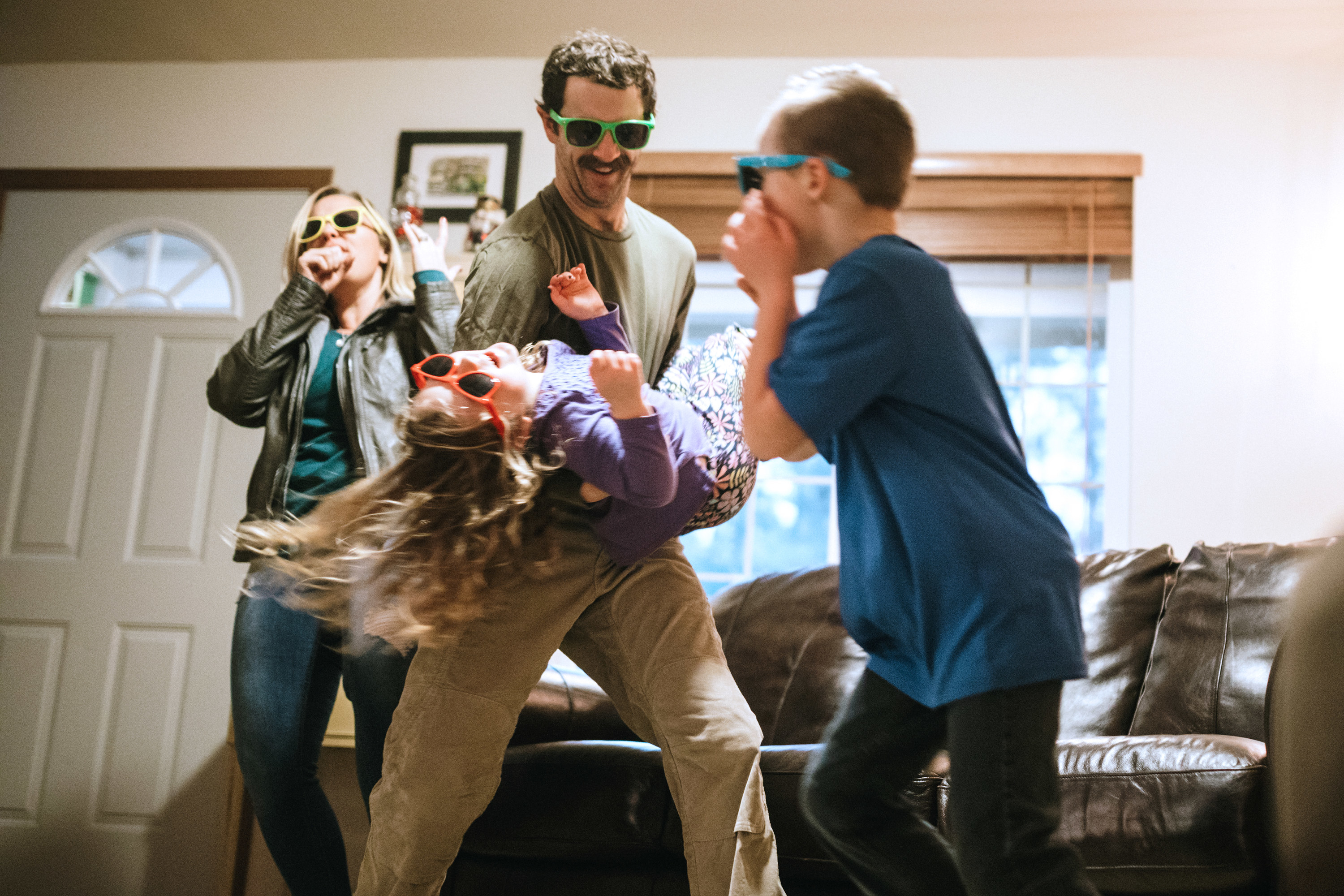 a family having a silly dance in their living room