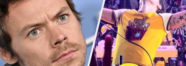 Harry Styles wears a black suit. He also appears in a yellow shirt and brown leather pants.