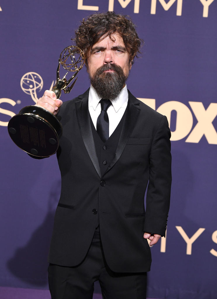 dinklage holding up his award