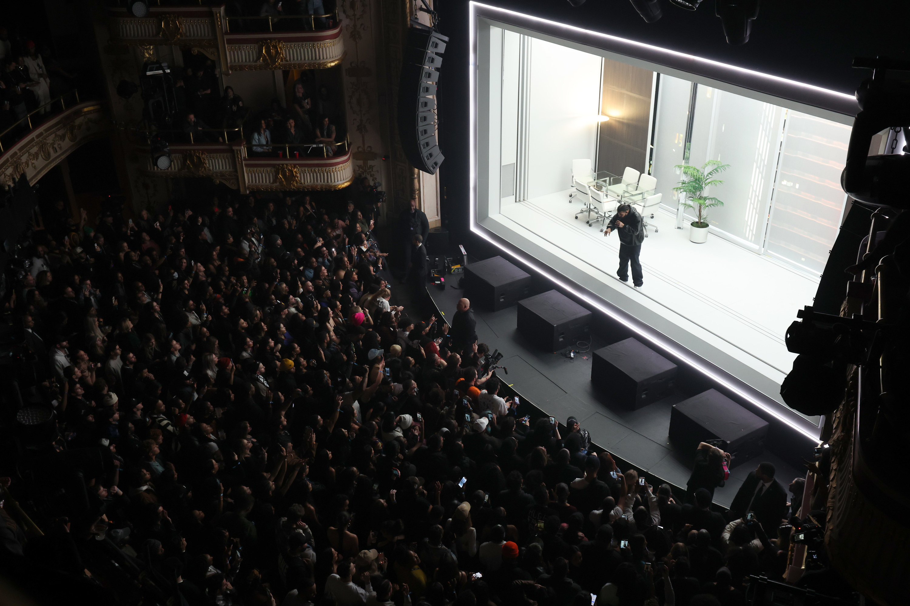 photo taken from a balcony of Drake rapping in front of a large crowd