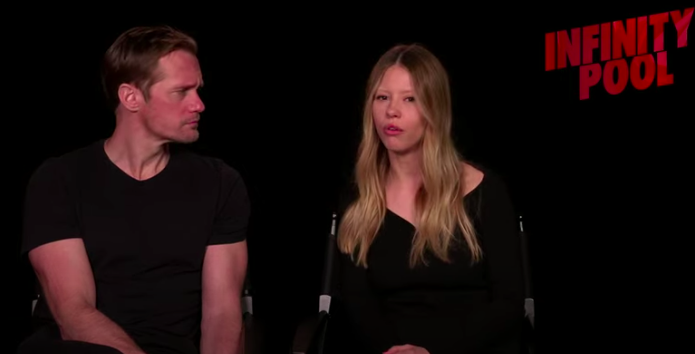 Alexander Skarsgard looks on as Mia speaks