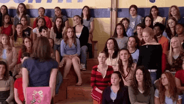 the students in the auditorium in Mean Girls all raising their hands at once