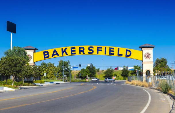 The Bakersfield arch sign over a two-way road