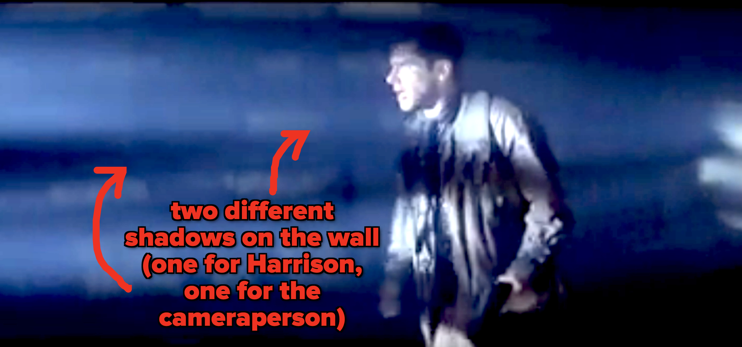 There are two shadows being cast on the wall; one by Harrison Ford who is by himself in the scene, and the other by the camera person filming him
