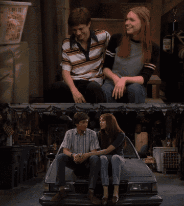 eric and donna playfully pushing each other&#x27;s heads in that 70s show and that 90s show