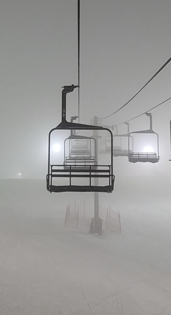 Ski lifts surrounded by fog