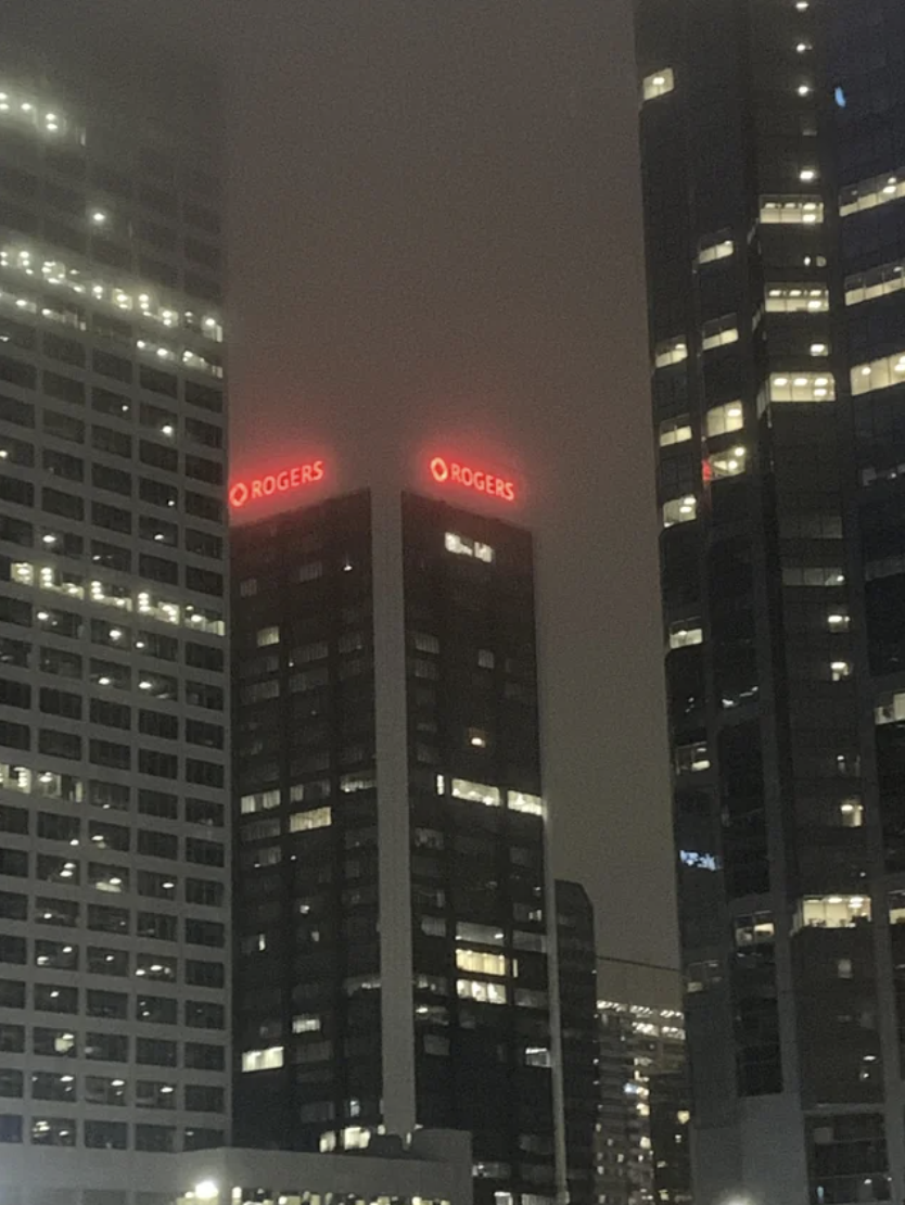 A building with the top covered in fog