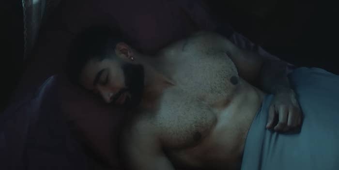 laith lying shirtless asleep in bed