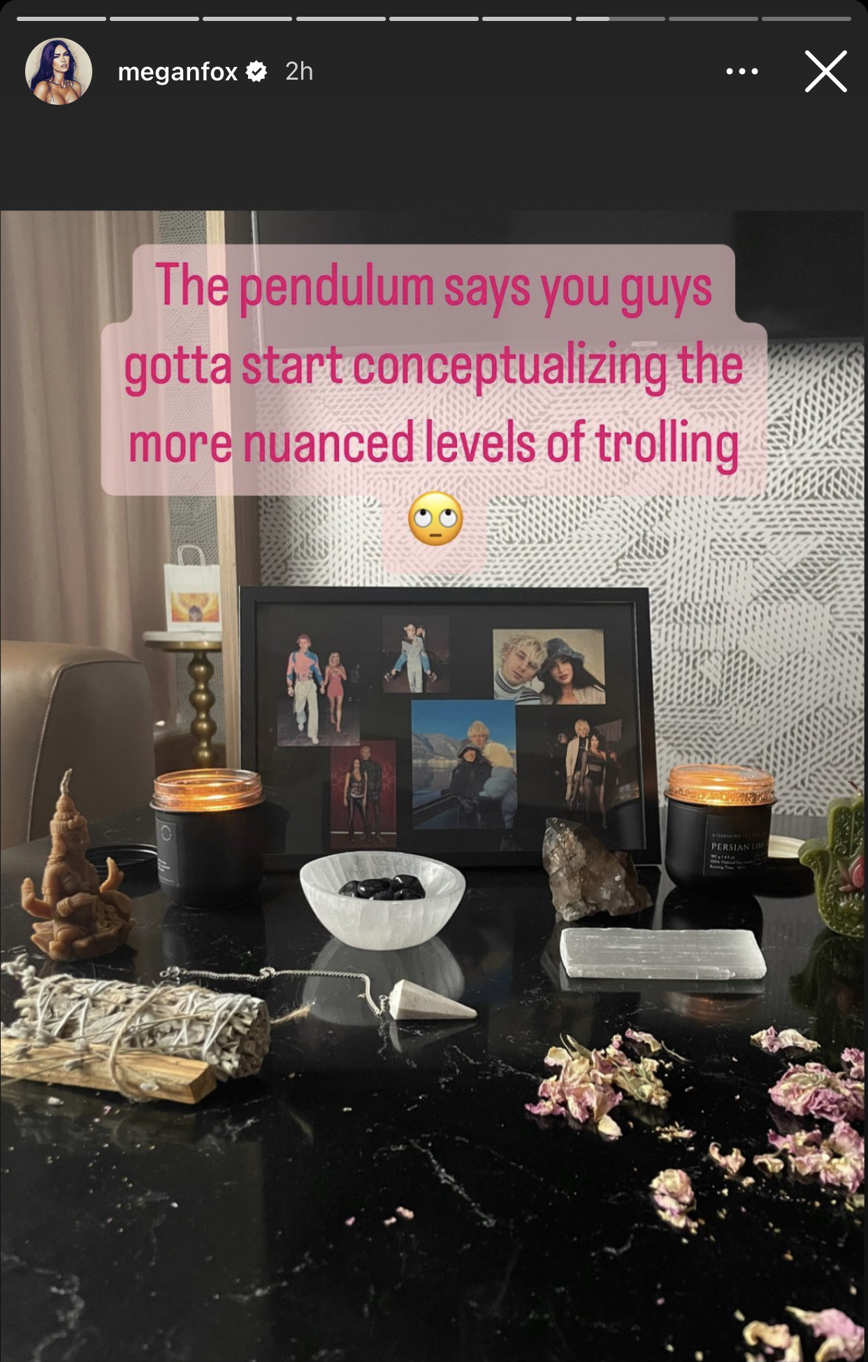 her message written over a photo of her table with a framed photo of the couple, crystals, sage, and and dried flowers
