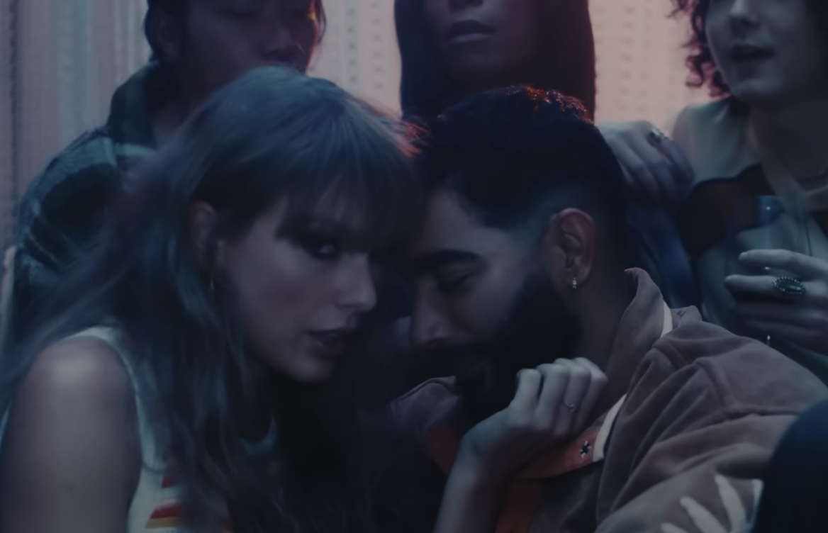 closeup of taylor and laith getting cozy at during a party scene