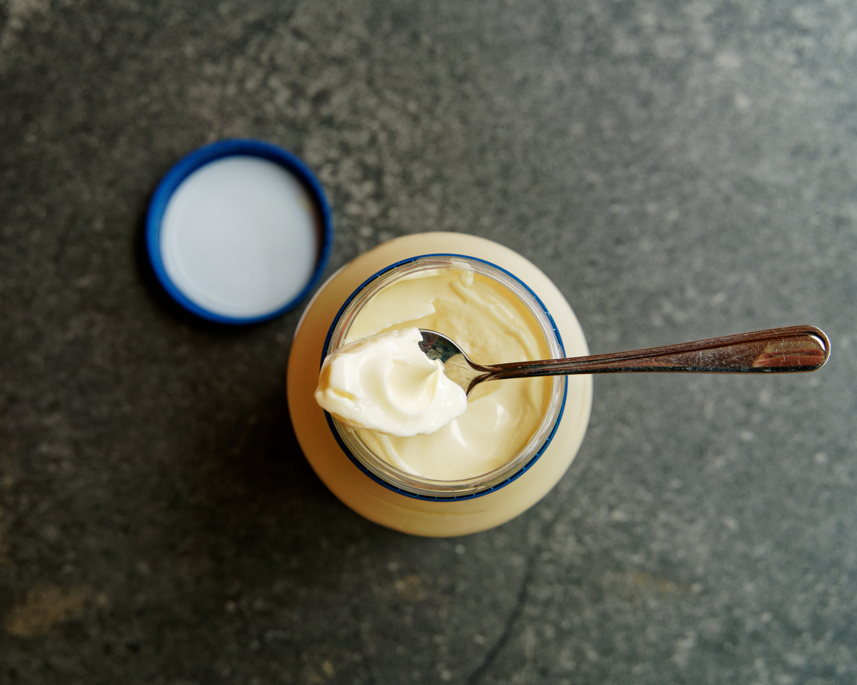 an overhead view of an open jar of mayo