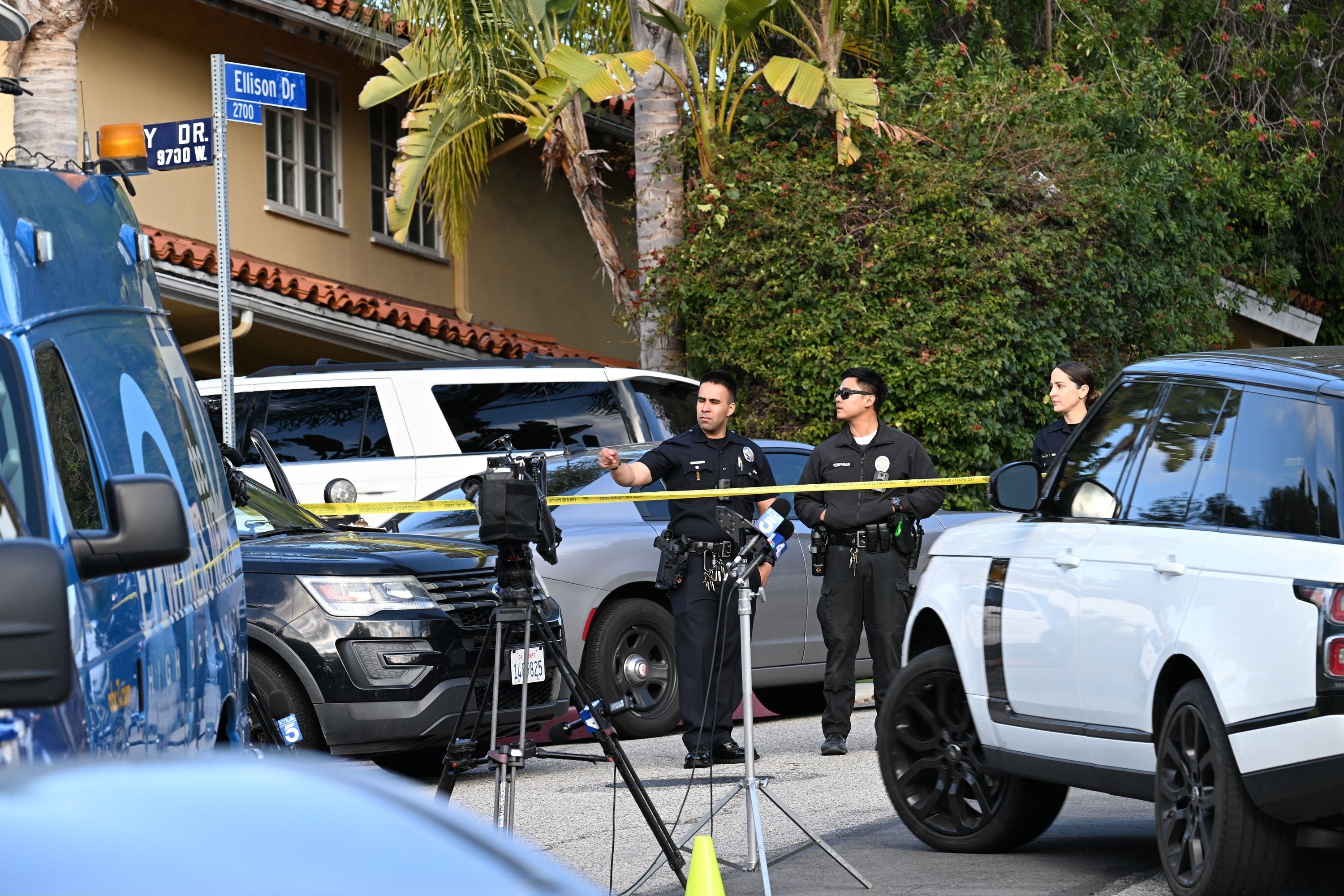 Police cars and officers surround the area where the shooting occurred.