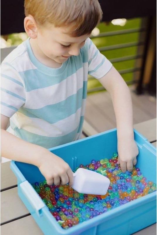 Child plays with sensory bin
