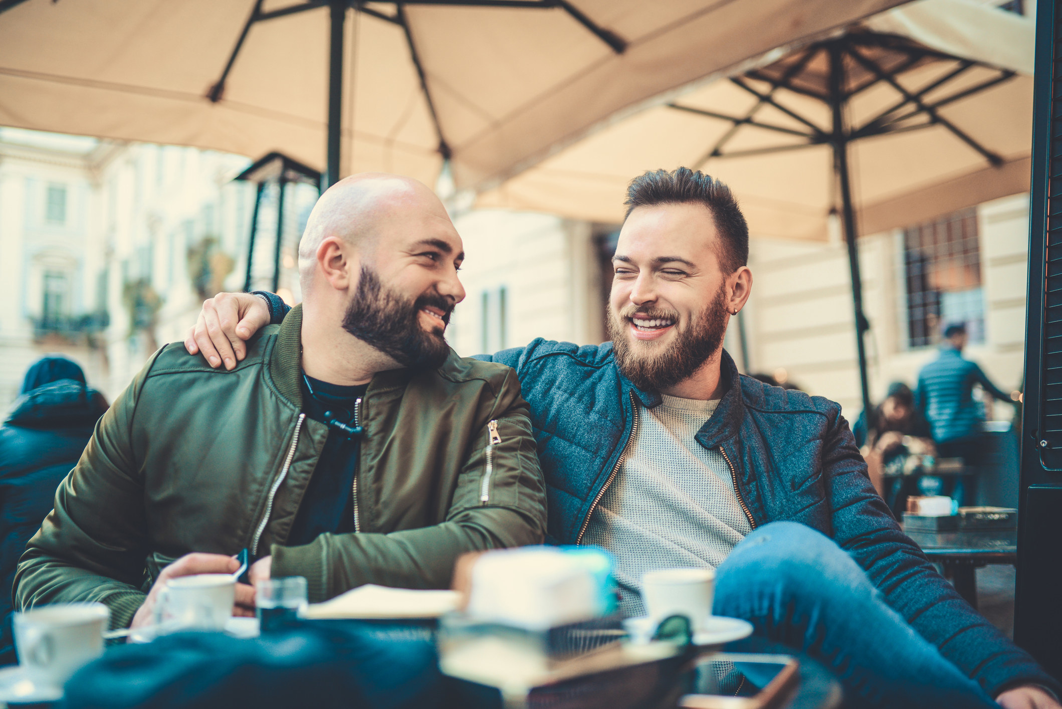 Two men smiling at each other