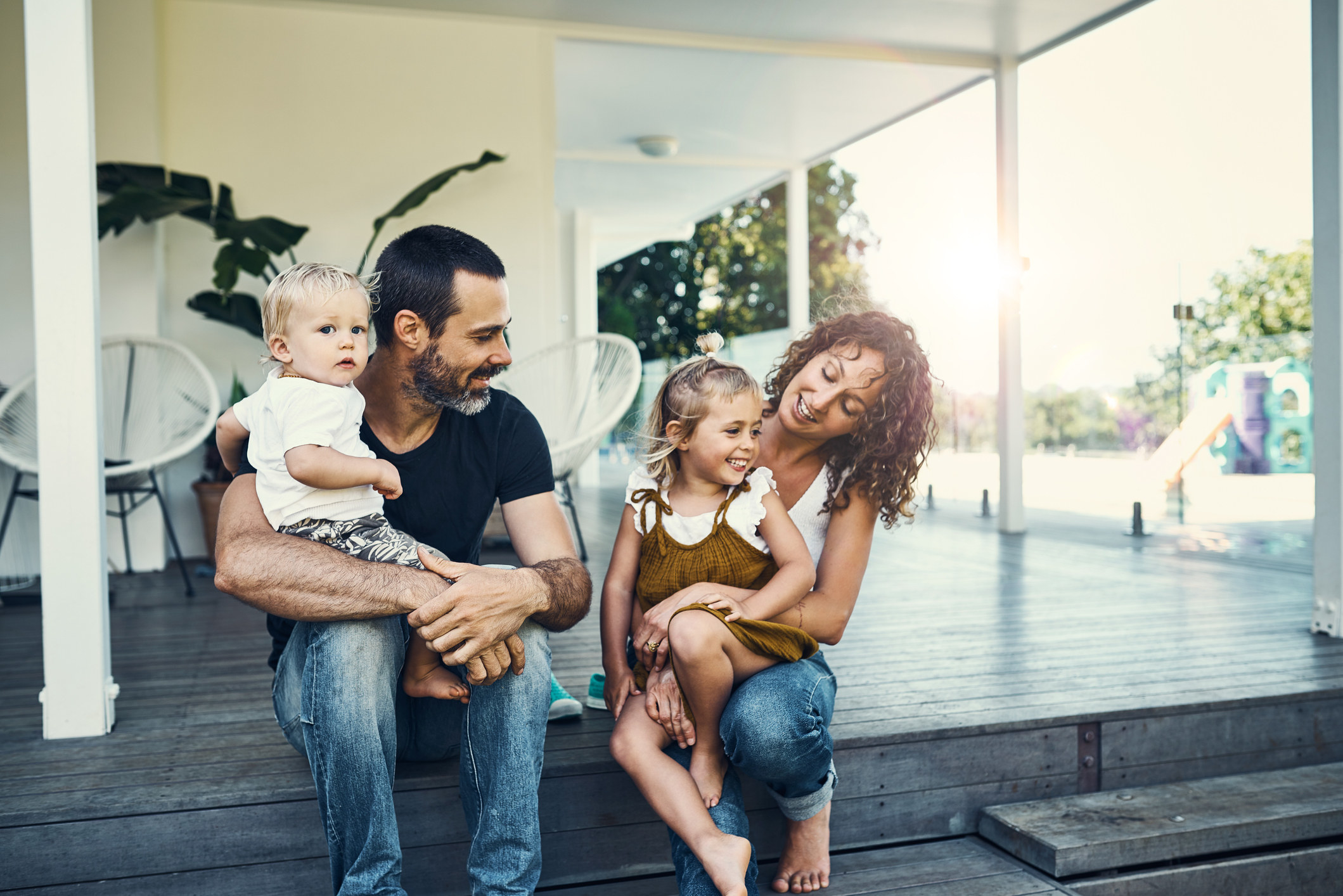 A couple on the porch with their kids