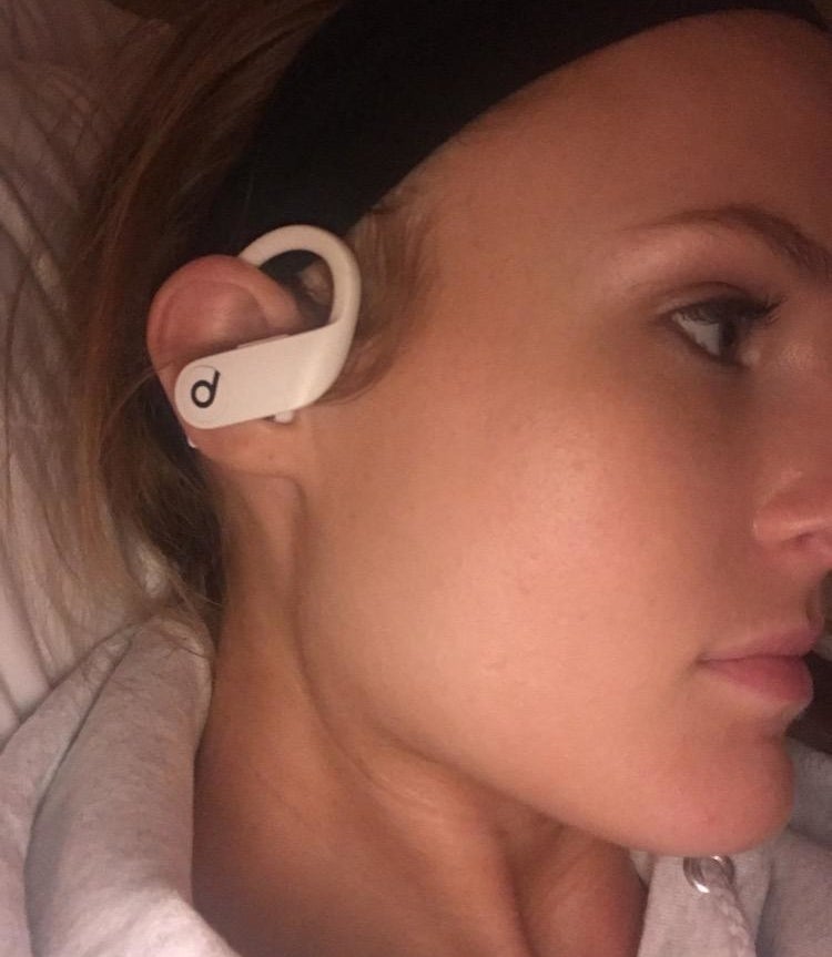 reviewer wearing the white earbud