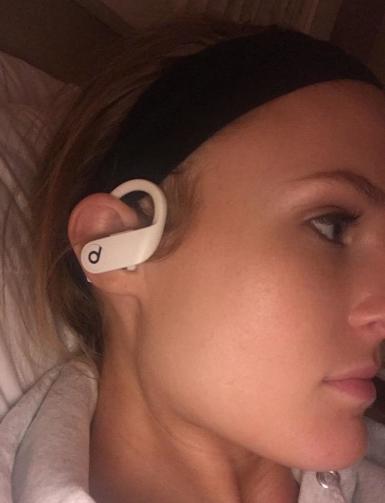reviewer wearing the white earbud