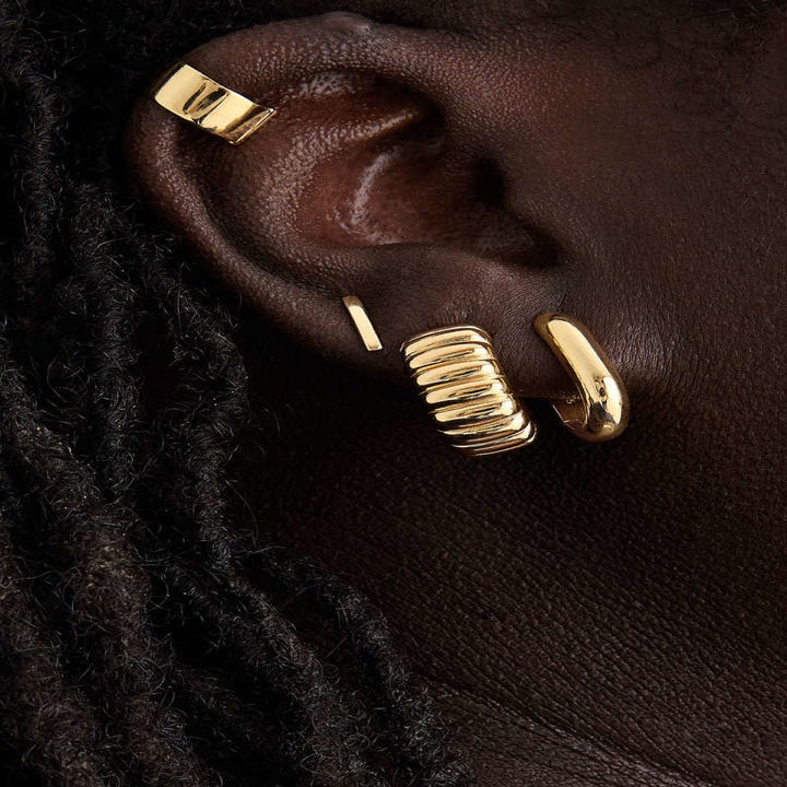 a person wearing the convertible earrings as huggies