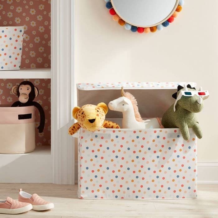 the polka dot box with stuffed animals peeking out