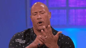 the rock pretending to scroll in his hand