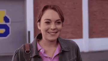 lindsay lohan as cady from mean girls waves and smiles with all her teeth