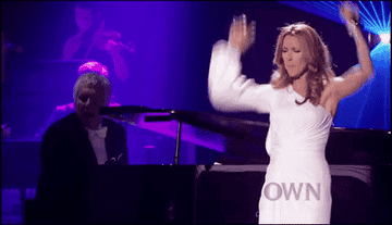 Celine Dion dramatically performing as a man plays the piano