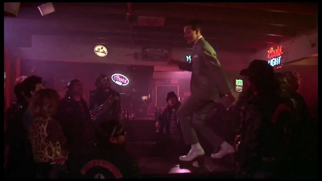 A man dances on a bar top