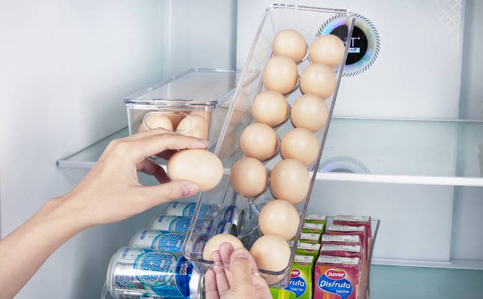 person grabbing an egg from the container