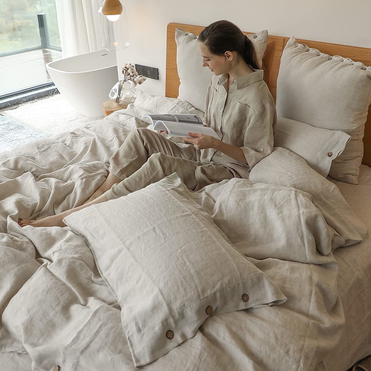 person sitting in bed with the duvet cover and pillow covers on