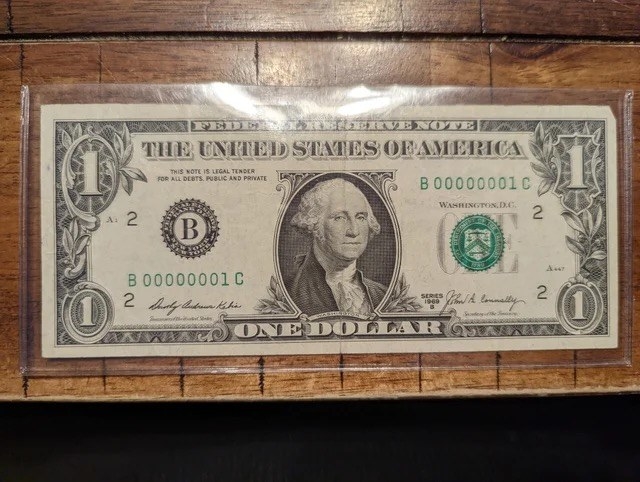 an old one dollar bill saved in plastic