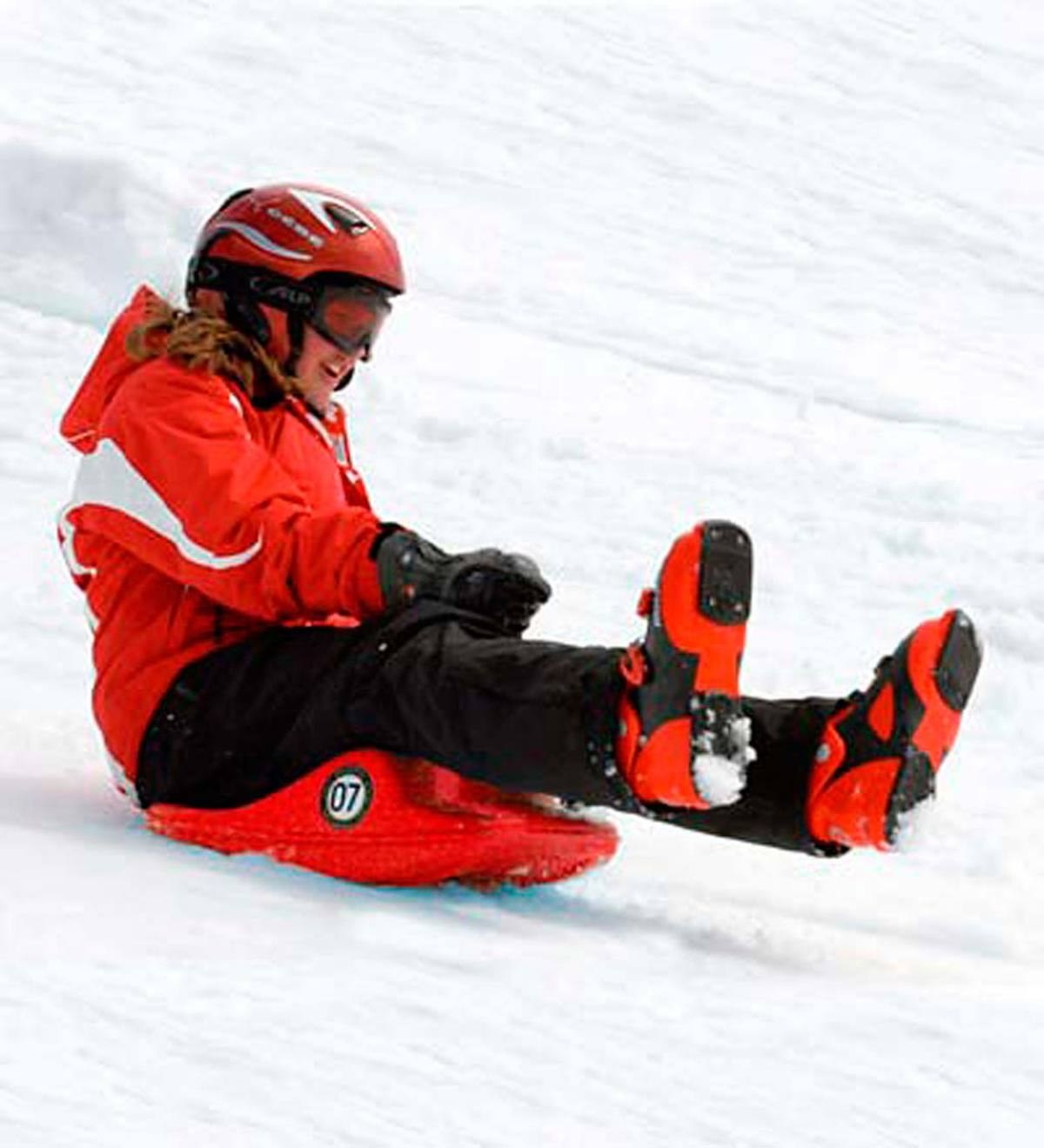 Child riding luge sled
