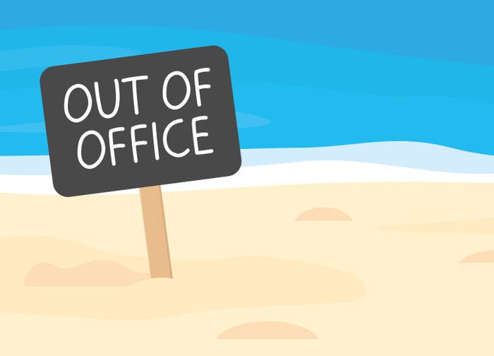 out of office written on sign board on sandy beach