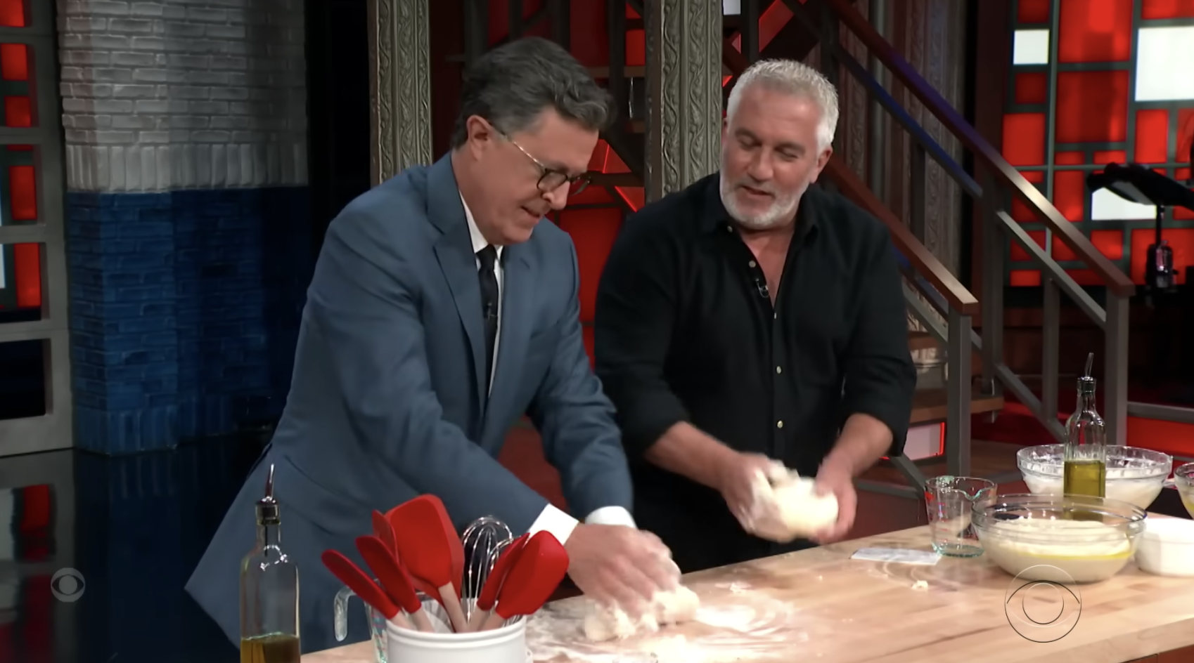 two men rolling out dough