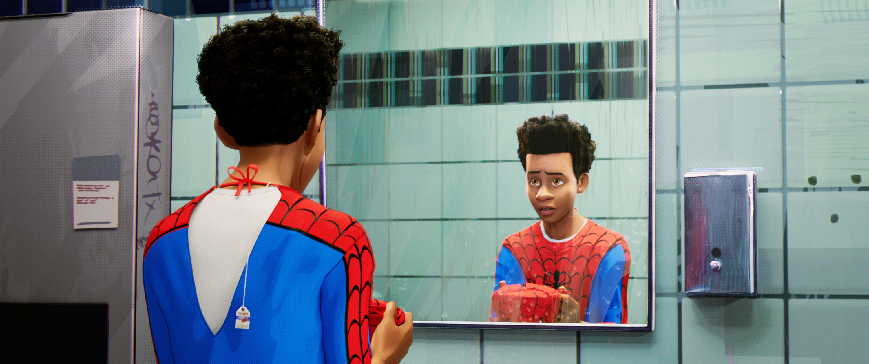miles looking at himself in the mirror while wearing his spider-man costume