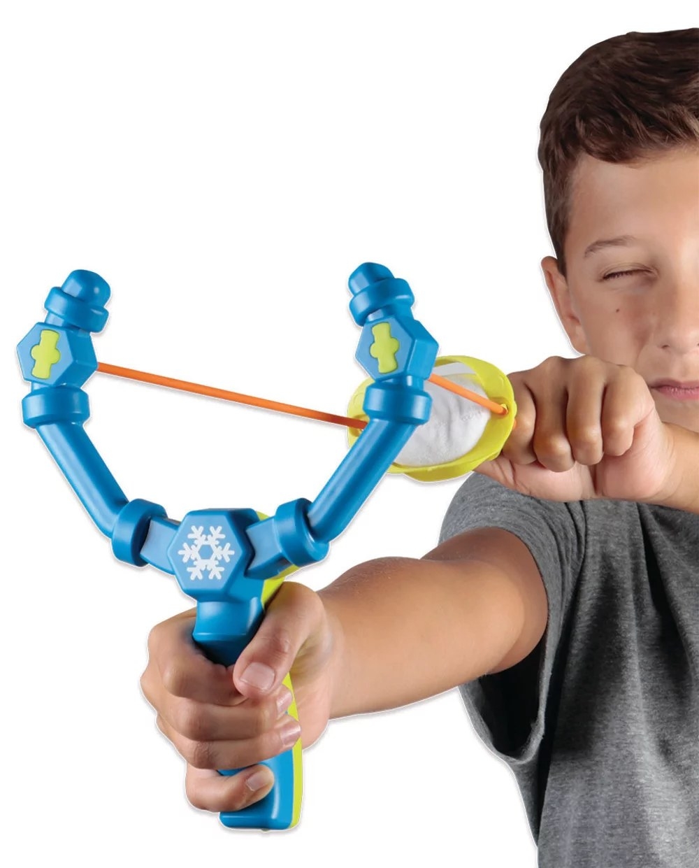 Boy using snowball launcher