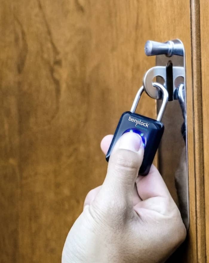 A person using their thumb to open the lock
