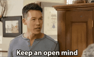 HGTV host ushering clients into room telling them to keep an open mind