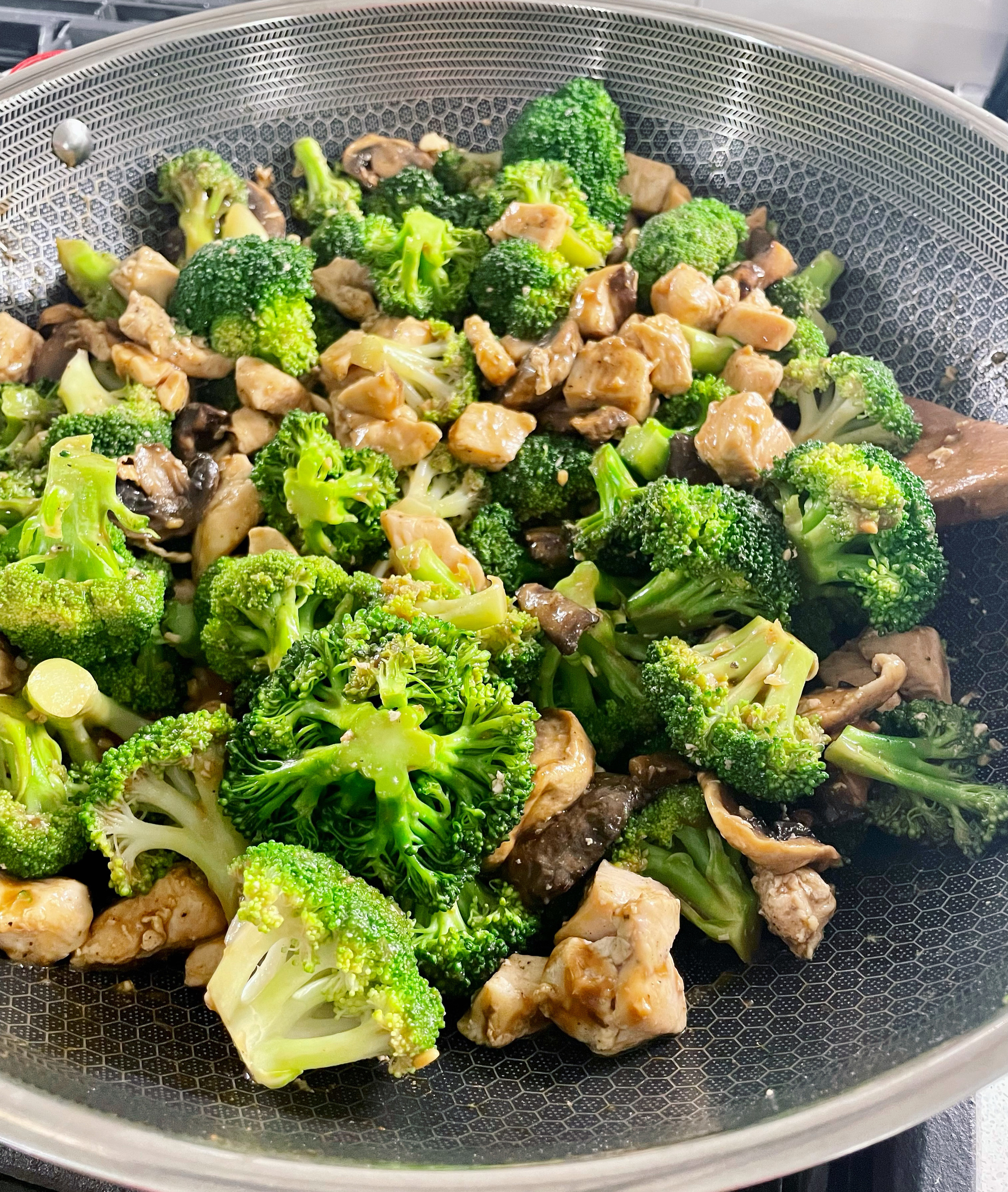 chicken and broccoli in a wok