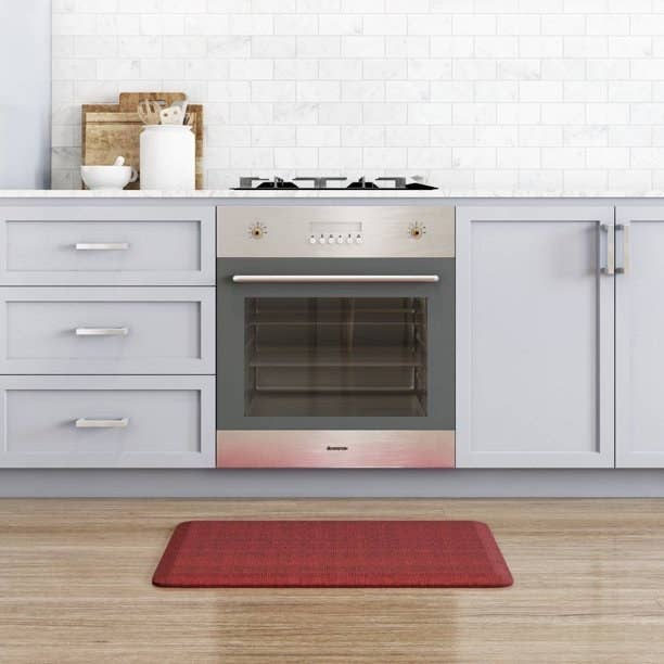 a barn red kitchen floor mat on a wooden floor in a kitchen