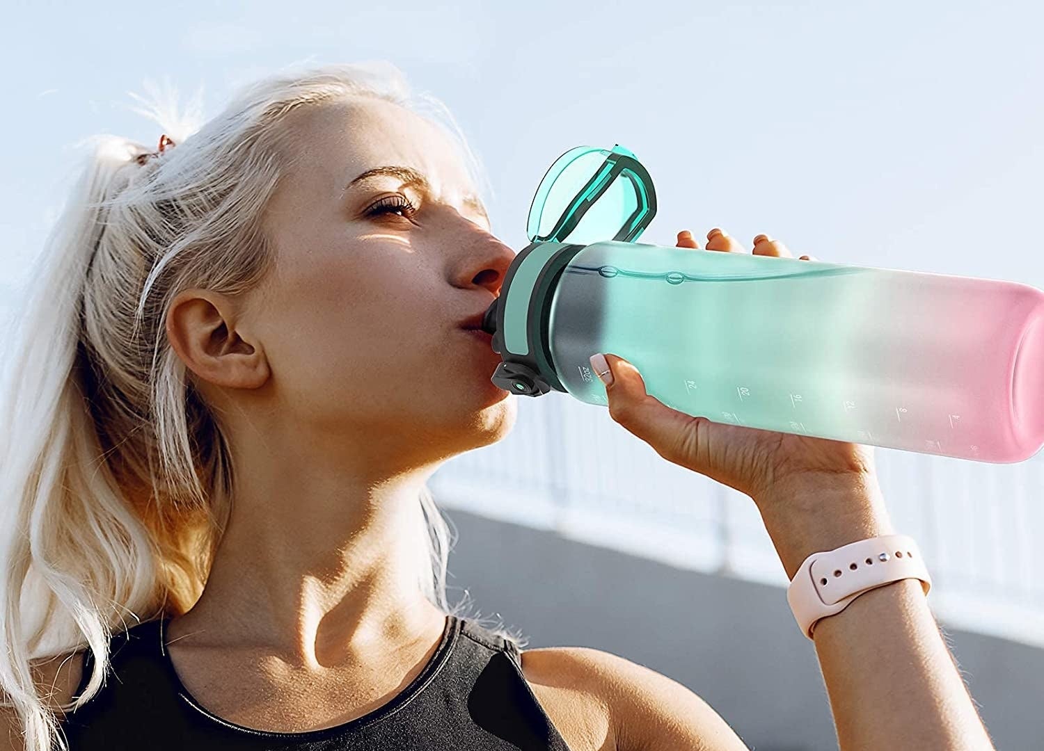 someone taking a sip from the motivational water bottle