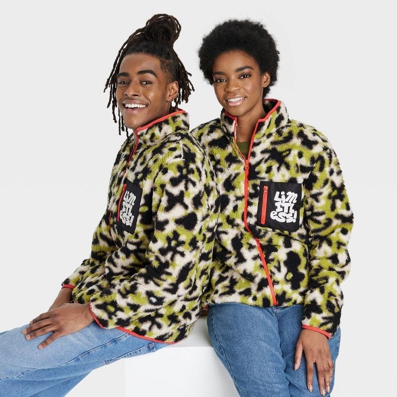 Two models wearing the green, black and white jacket with jeans