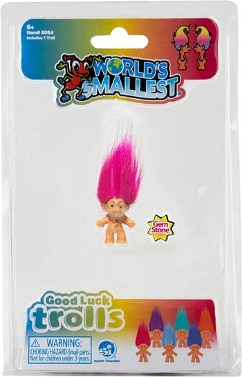 packaging for a troll doll with pink hair