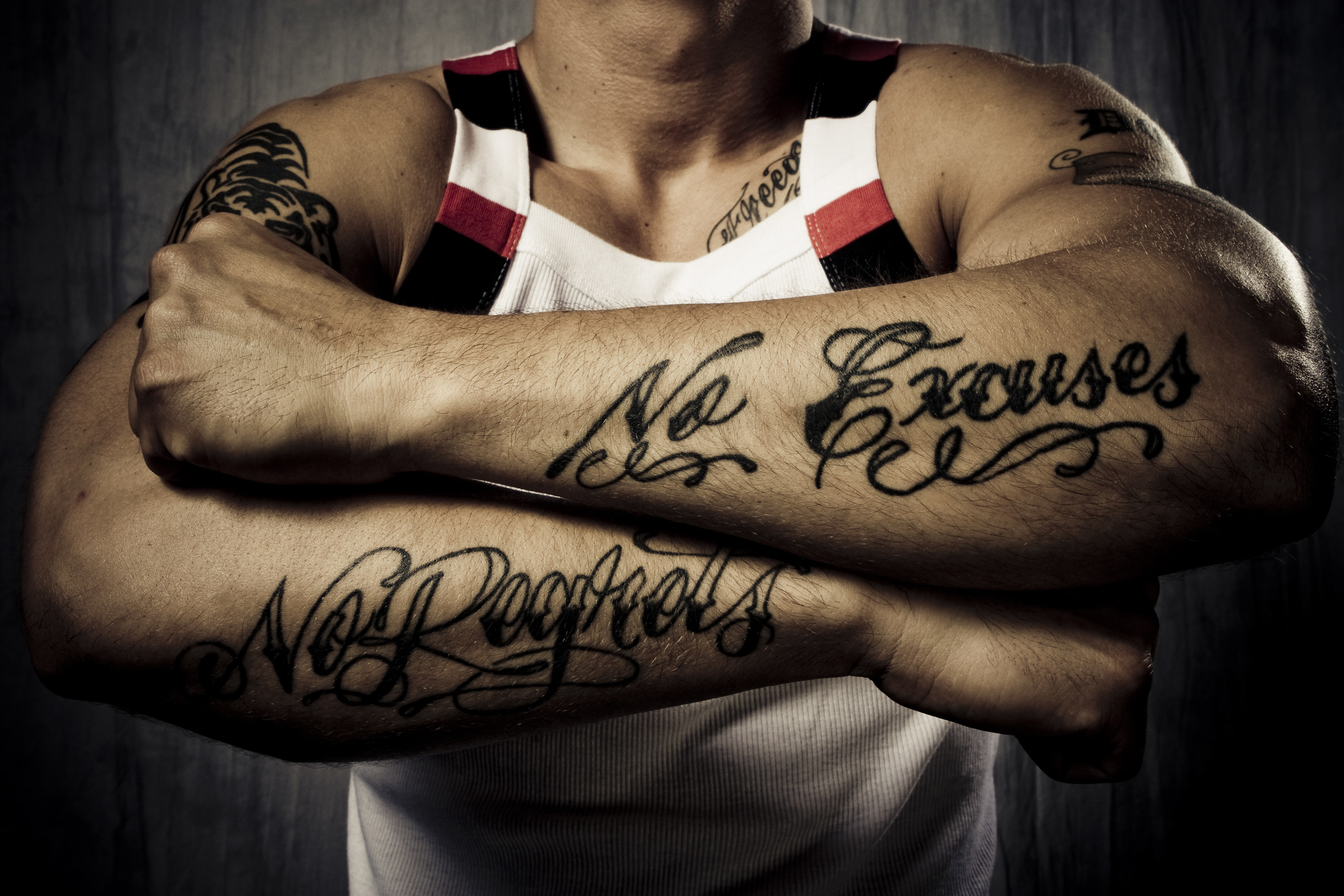 A man showing his arm tattoos